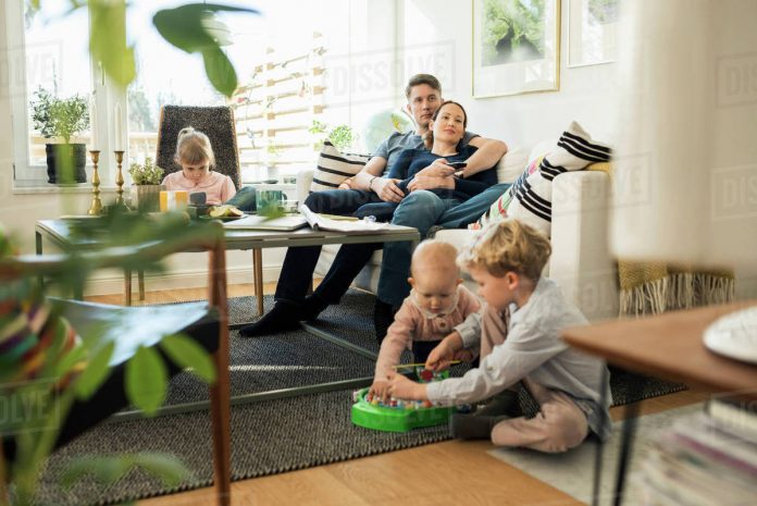 Kids- playing- with -parents- relaxing - at home-kidhours